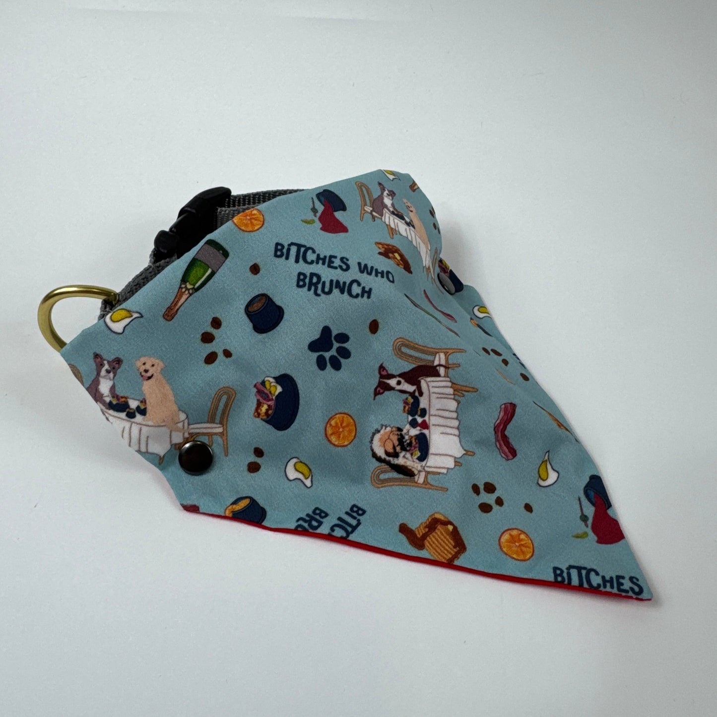 Fabric bandana with dog-themed print on a white background