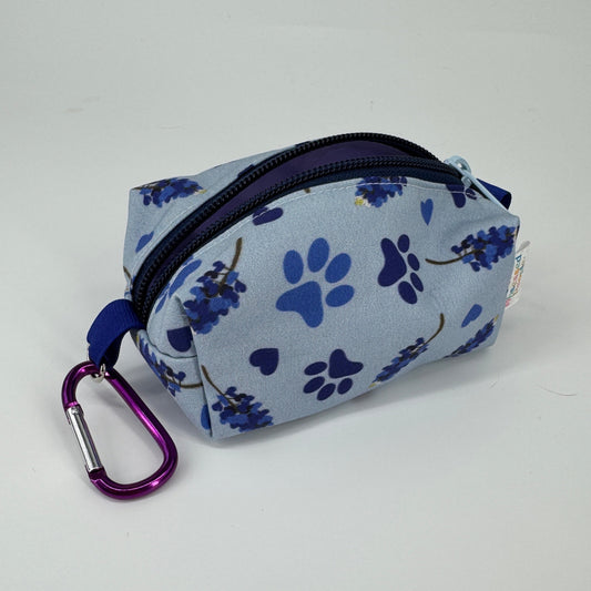 Small pouch with blue floral pattern and purple carabiner on a white background
