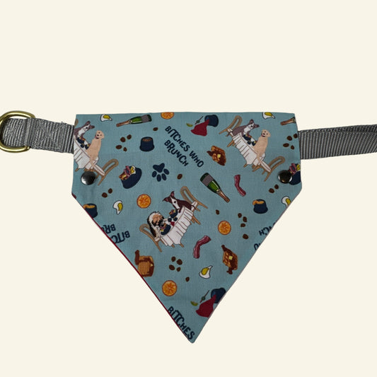 Triangle-shaped pet toy with patterned fabric and gray strap on a white background